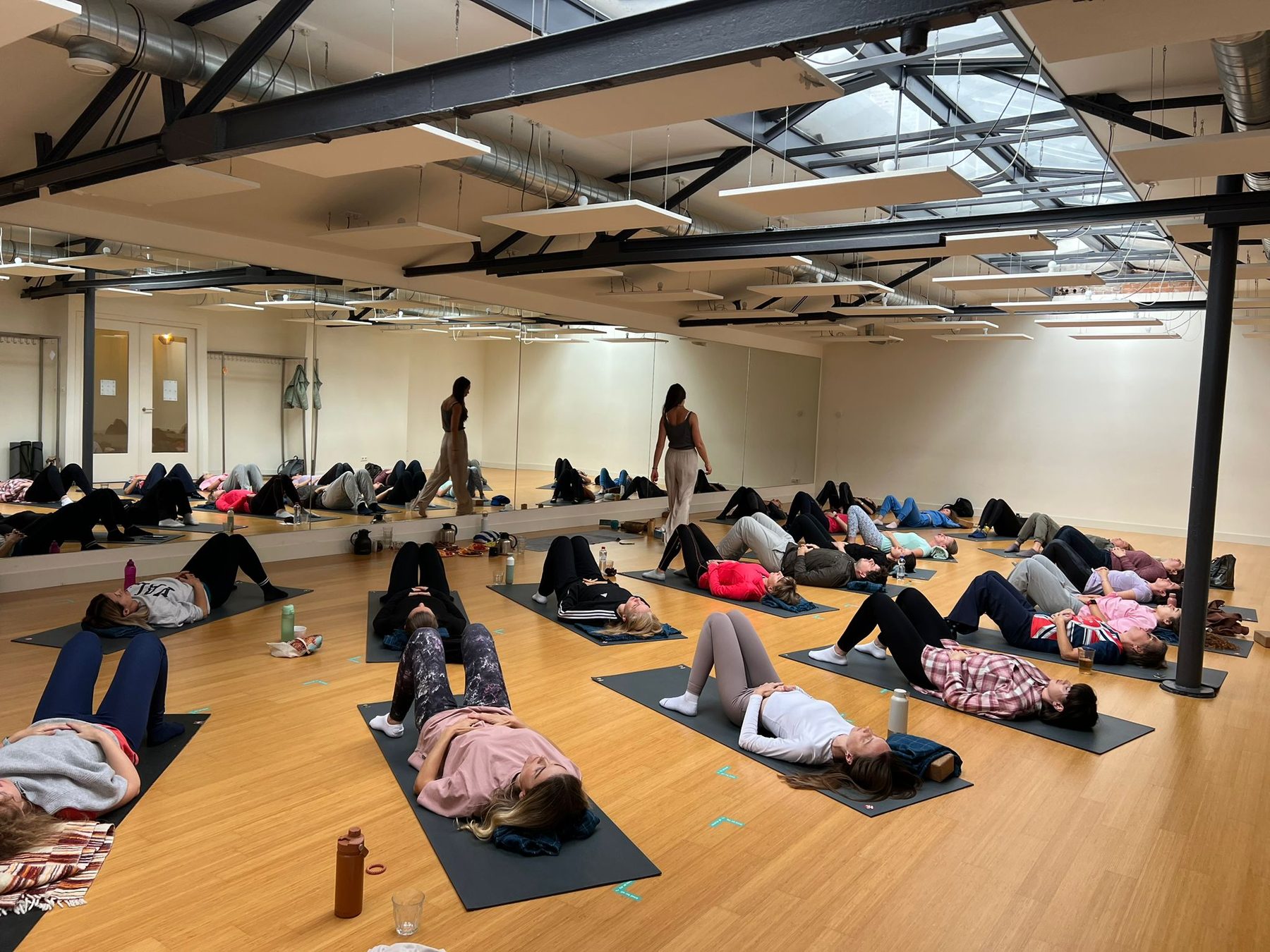 A yoga and movement class lying on mats together
